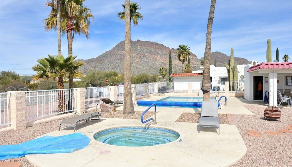 Sunny community pool area with lounge chairs