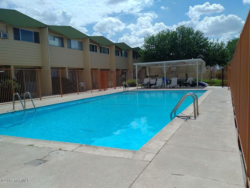 A pool with a blue water and some buildings